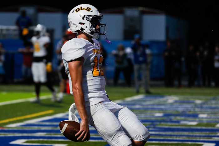 Warren De La Salle quarterback Brady Drogosh (12) scores a touchdown against Brother Rice during the first half at Lawrence Tech in Southfield on Friday, Sept. 17, 2021.